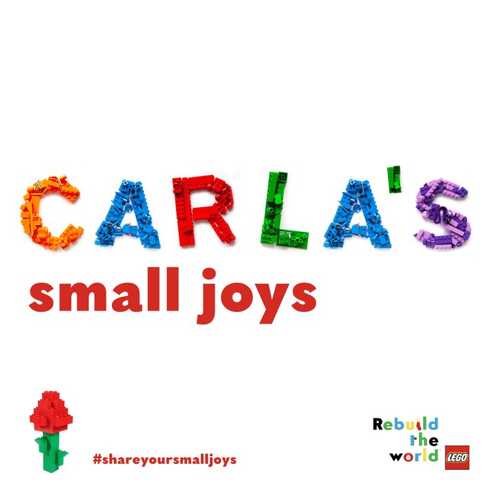 A square post on white: the name Carla's spelled in loose LEGO bricks in orange, blue, red, green and purple, small joys in red below, and a brick-built rose in the corner.
