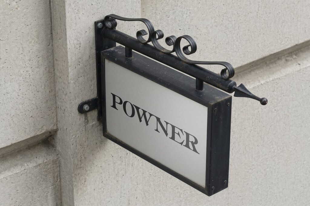 Black iron hanging sign with the name lettered in Powner.